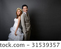 young asian groom and bride posing in studio  31539357