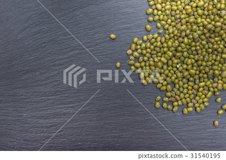 Green mung bean on black background of slate or Green mung bean on black background of slate or 31540195