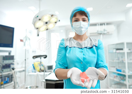 Female doctor holding breast cancer awareness pink Female doctor holding breast cancer awareness pink 31541030