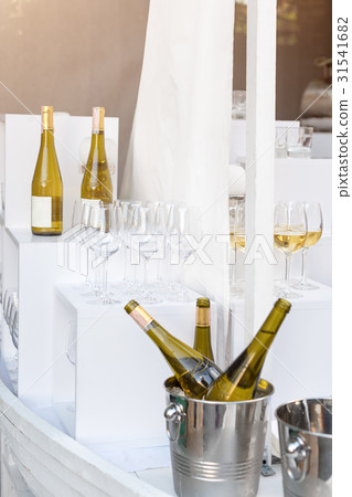 Bottles of white wine standing on serving table 31541682