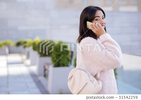 Active emotional lady talking to someone on the 31542259