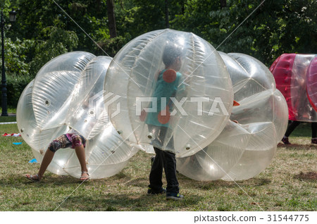 Teenagers play in Bubble bump 31544775