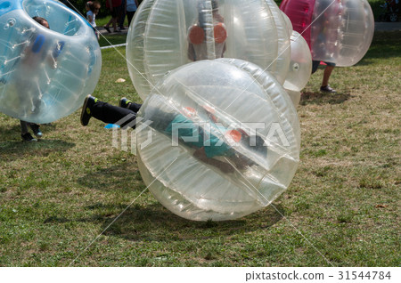 Teenagers play in Bubble bump 31544784