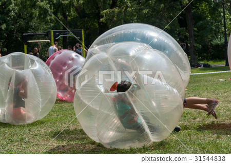 Teenagers play in Bubble bump 31544838