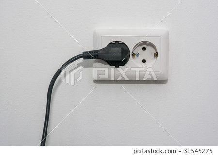 Male hand puts plug in the socket Male hand puts plug in the socket 31545275