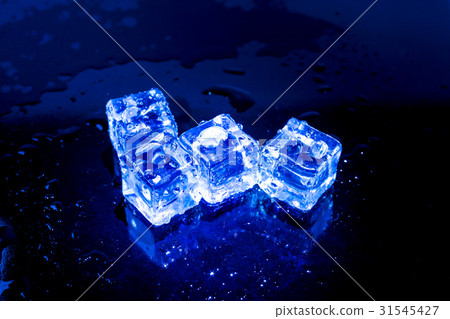 Blue ice cubes on black wet table. 31545427