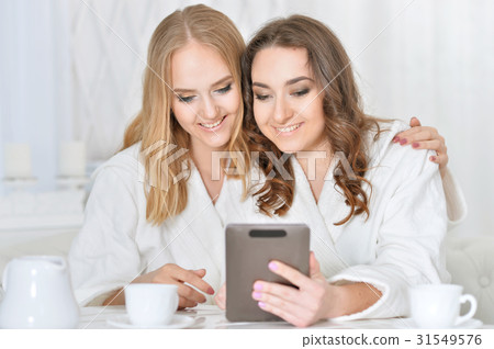 Two girlfriends with a tablet Two girlfriends with a tablet 31549576
