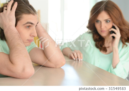 Young man holding hands on head Young man holding hands on head 31549583