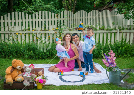 A couple sitting with the children A couple sitting with the children 31551340
