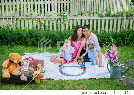 A couple sitting with the children A couple sitting with the children 31551342