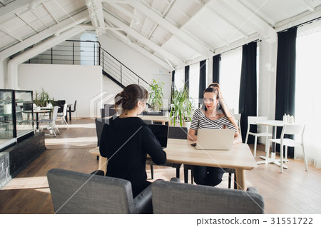 Female business team having a meeting together to 31551722