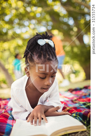 Happy girl reading a book Happy girl reading a book 31555734