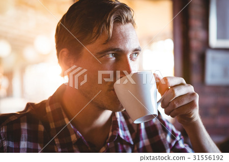 Man drinking a cup of coffee Man drinking a cup of coffee 31556192