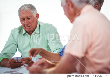 Smiling seniors people playing cards 31556196