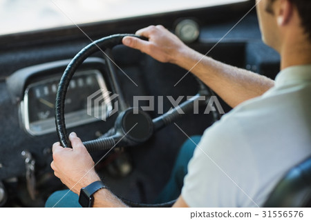 Bus driver driving a bus Bus driver driving a bus 31556576