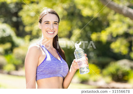 Portrait of woman holding water bottle 31556678