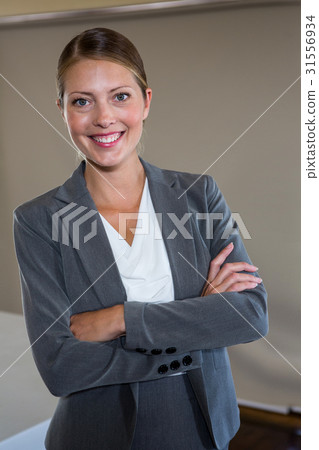 Woman standing with arms crossed Woman standing with arms crossed 31556934