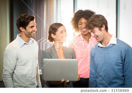 Business people having discussion over laptop Business people having discussion over laptop 31556989