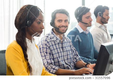 Team working on computer with headset 31557096