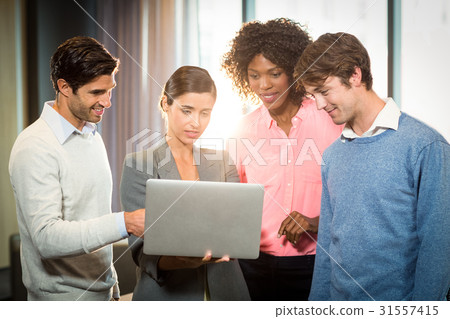 business people having discussion over laptop 31557415