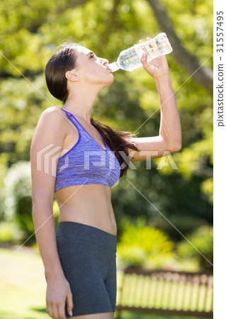 Woman drinking water from water bottle 31557495