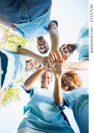 Portrait of volunteer group forming huddles 31557596
