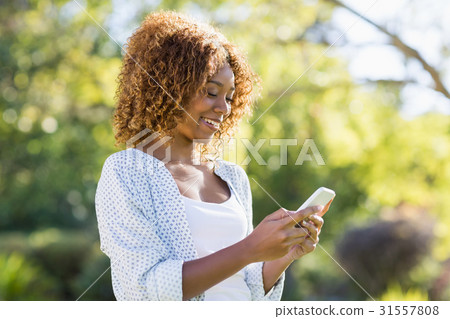 Young woman using mobile phone Young woman using mobile phone 31557808