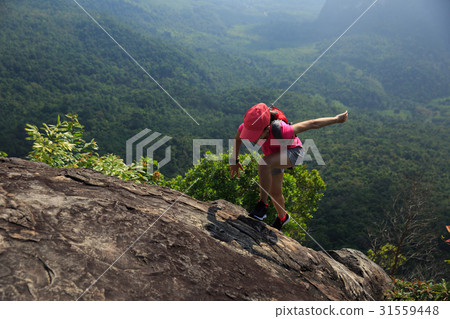 Young woman trail runner running at mountain top 31559448