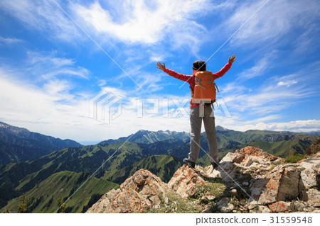 successful woman backpacker open arms on mountain peak 31559548