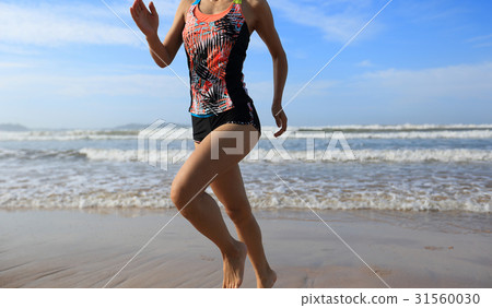 young fitness woman running to the sea young fitness woman running to the sea 31560030