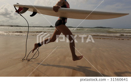 young woman surfer withsurfboard ready to surf 31560641