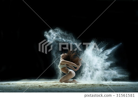 Woman in a cloud of white dust studio portrait Woman in a cloud of white dust studio portrait 31561581