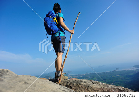woman hiker enjoy the view hiking on mountain peak 31563732