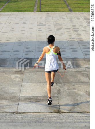 fitness sports woman running up on stone stairs 31566208