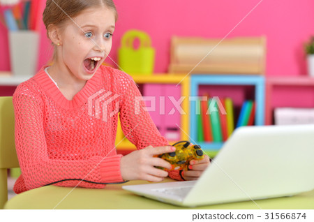 girl playing game on laptop girl playing game on laptop 31566874