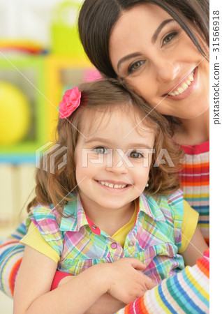 young mother hugging with little daughter young mother hugging with little daughter 31566918