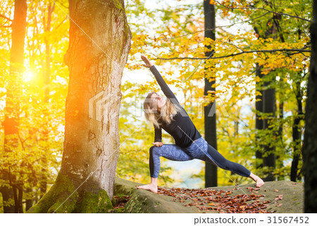 Woman is practicing yoga on the top of mountain 31567452