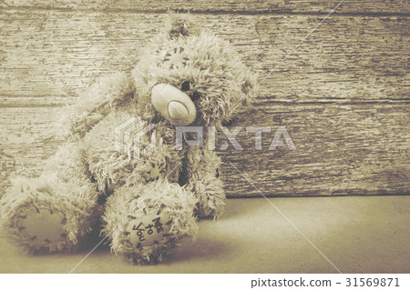 Cute teddy bear on brown wooden background 31569871