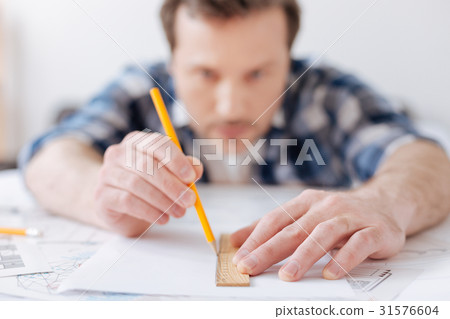 Close up photo of male hands while drawing plan 31576604