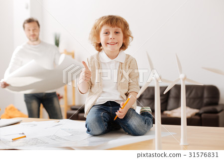 Positive delighted kid being pleased with new toys 31576831