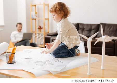 Funny kid sitting on his legs on the table 31576842