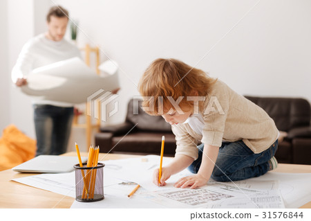 Attentive man looking at pictures while standing 31576844