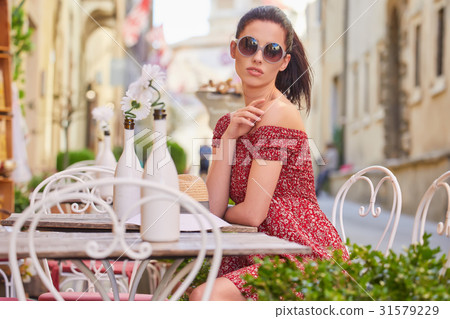 woman having italian coffee at the cafe on the street in Toscana 31579229