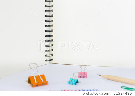 note book and paper clips on white background note book and paper clips on white background 31584480