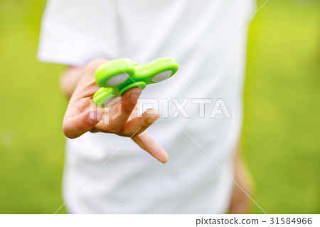 School kid playing with Tri Fidget Hand Spinner 31584966