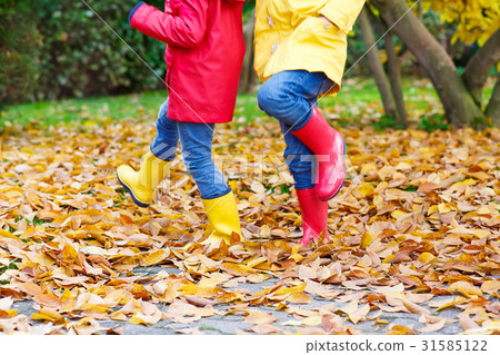 Two little children playing in red and yellow Two little children playing in red and yellow 31585122