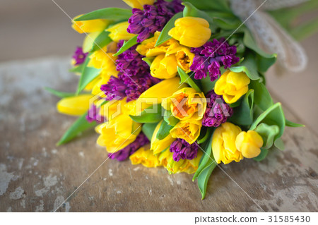 Yellow tulips and purple hyacinths flowers bouquet Yellow tulips and purple hyacinths flowers bouquet 31585430