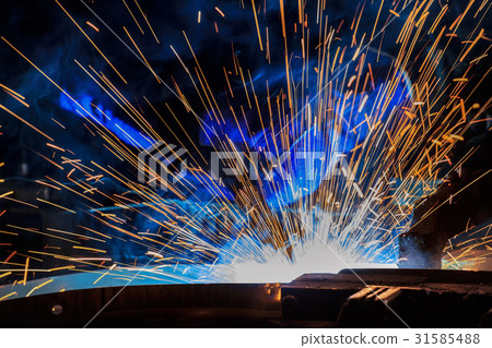 Worker is welding automotive part in car factory 31585488