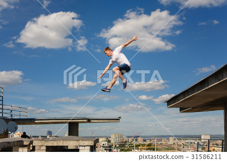 Man jumps from roof to roof. Parkour 31586211