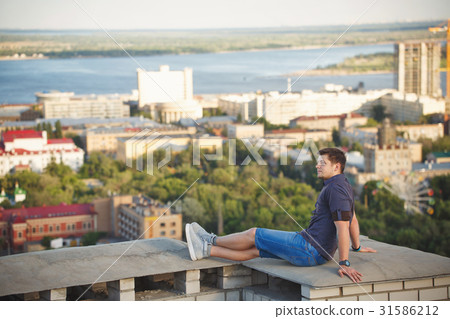 Roofer sits on the roof Roofer sits on the roof 31586212